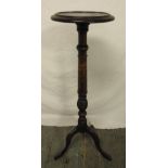 A mahogany plant stand of knopped cylindrical form on three outswept legs