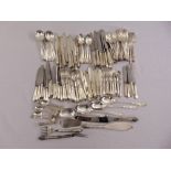 A quantity of silver plated flatware to include knives, forks, spoons and servers