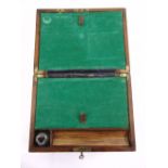 A Victorian mahogany rectangular writing slope with brass mounts, detachable glass inkwell and key