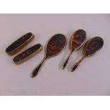 Silver and tortoiseshell five piece dressing table set, to include a pair of hair brushes, a pair of