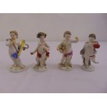 Four Meissen figurines of putti on raised circular bases, marks to the bases