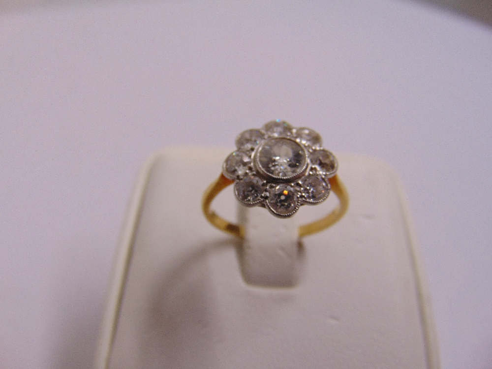 18ct yellow gold, platinum and diamond dress ring, set with nine stones, the centre stone approx