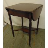 An Edwardian mahogany rectangular drop flap tea table on tapering legs