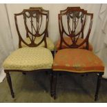 Four Edwardian mahogany dining chairs with pierced shield backs, on tapering cylindrical legs
