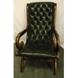 A mahogany and green leather occasional chair with scrolling arms and legs