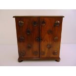 A Victorian mahogany rectangular table cabinet with two hinged doors with circular motifs, five