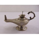 A white metal Middle Eastern oil lamp of Aladdin form with serpent handle on circular spreading