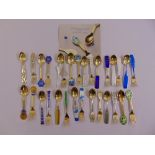 A quantity of Royal Copenhagen white and yellow metal, enamel spoon and fork sets issued yearly by