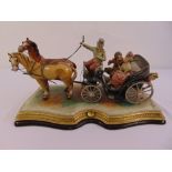 Capodimonte figural group of a courting couple in an open carriage signed to the base B. Merli