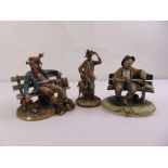 Three Capodimonte figurines to include a hunter and two gentlemen of the road seated on benches, all