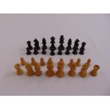 A hand turned wooden miniature chess set
