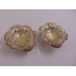 A pair of Victorian silver scroll pierced oval bonbon dishes on four ball feet, Birmingham 1895