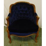 An early 20th century mahogany upholstered continental occasional chair on cabriole legs