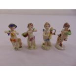 Four Capodimonte figurines of putti, marks to the bases