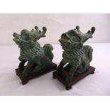 A pair of 20th century Chinese bronze Dogs of Foe on carved hardwood stands