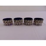 A set of four continental white metal salts, oval, pierced leaf and scroll sides with detachable