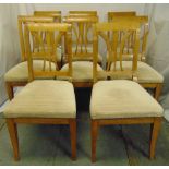 A set of eight Biedermeier style fruitwood dining chairs with upholstered seats on sabre legs