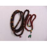 Two Oriental bead necklaces to include horn and seed
