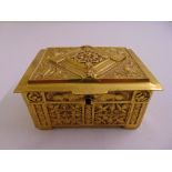 A continental rectangular gilt metal jewellery casket embossed with stylised animals, birds and