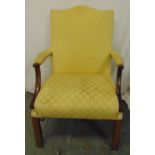 A mahogany high back upholstered armchair on four rectangular legs