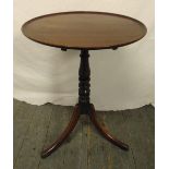 A Victorian circular mahogany tilt top side table on three outswept legs