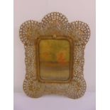 A shaped rectangular scroll pierced brass photograph frame