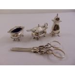 A pair of silver grape scissors and a three piece silver condiment set