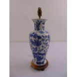 A Chinese blue and white baluster vase lamp stand decorated with floral sprays and leaves, mounted