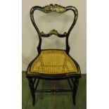 A 19th century lacquered mother of pearl inlaid boudoir chair with hand caned seat and ebonised