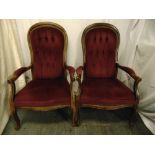 A pair of mahogany button back upholstered armchairs on scroll legs