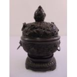 A late 19th century Chinese bronze incense burner, of circular form with raised pull off cover and