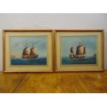 A pair of framed and glazed paintings of ships at sea, each 18 x 23cm