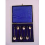 A cased set of six silver coffee spoons with bean terminals