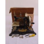 An early 20th century continental sewing machine in original packaging with accessories