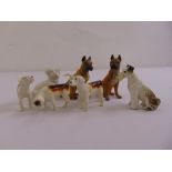 Seven ceramic figurines of dogs to include a variety of pedigrees