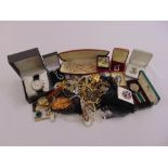 A quantity of costume jewellery to include necklaces, brooches, pendants and a watch