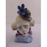 A Lladro figurine of a clown with a bow tie and bowler hat