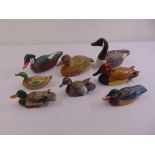 Eight hand painted carved duck decoys of varying size and style