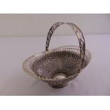 A continental white metal fruit basket oval with pierced basket weave sides and swing handle