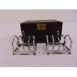 A pair of cased five bar silver toast racks, Birmingham 1932