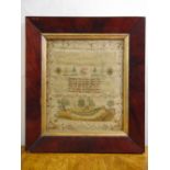 A Georgian framed and glazed sampler for Charlotte Clark 1805 depicting flowers and leaves and a