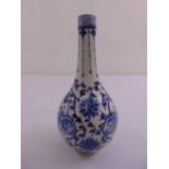 A Chinese blue and white bottle vase decorated with figures, scrolls and stylised leaves