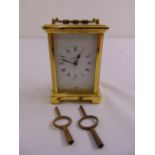 A Bayard brass carriage clock of customary form with white enamel dial and Roman numerals to include