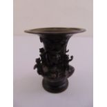 A Chinese cast bronze vase with applied figures and vegetation to the sides