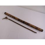 An Aboriginal didgeridoo and a walking stick with horn handle