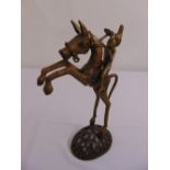 An Ashanti cast metal figurine of a horse and rider on raised oval base