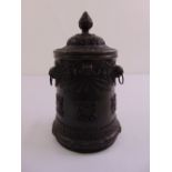 A Tibetan cylindrical bronze brush pot with side handles and pull-off cover