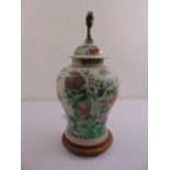 A Chinese famille rose baluster vase and cover converted to a table lamp on raised hardwood stand