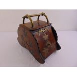A Victorian oak shaped oval coal scuttle with brass mounts and carrying handle