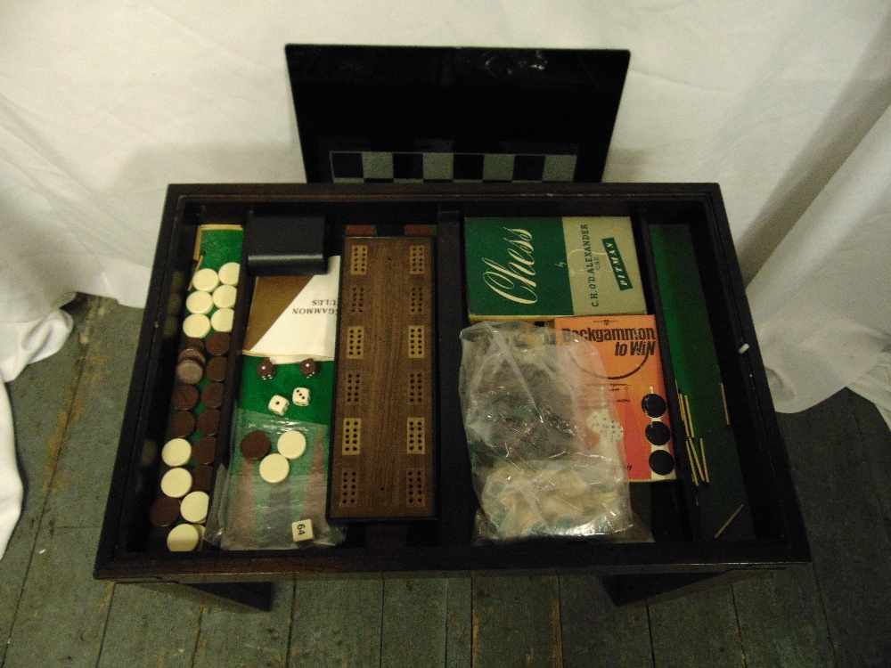 A 1960s mahogany rectangular games table the glass sliding top opening to reveal a compendium of - Image 2 of 2